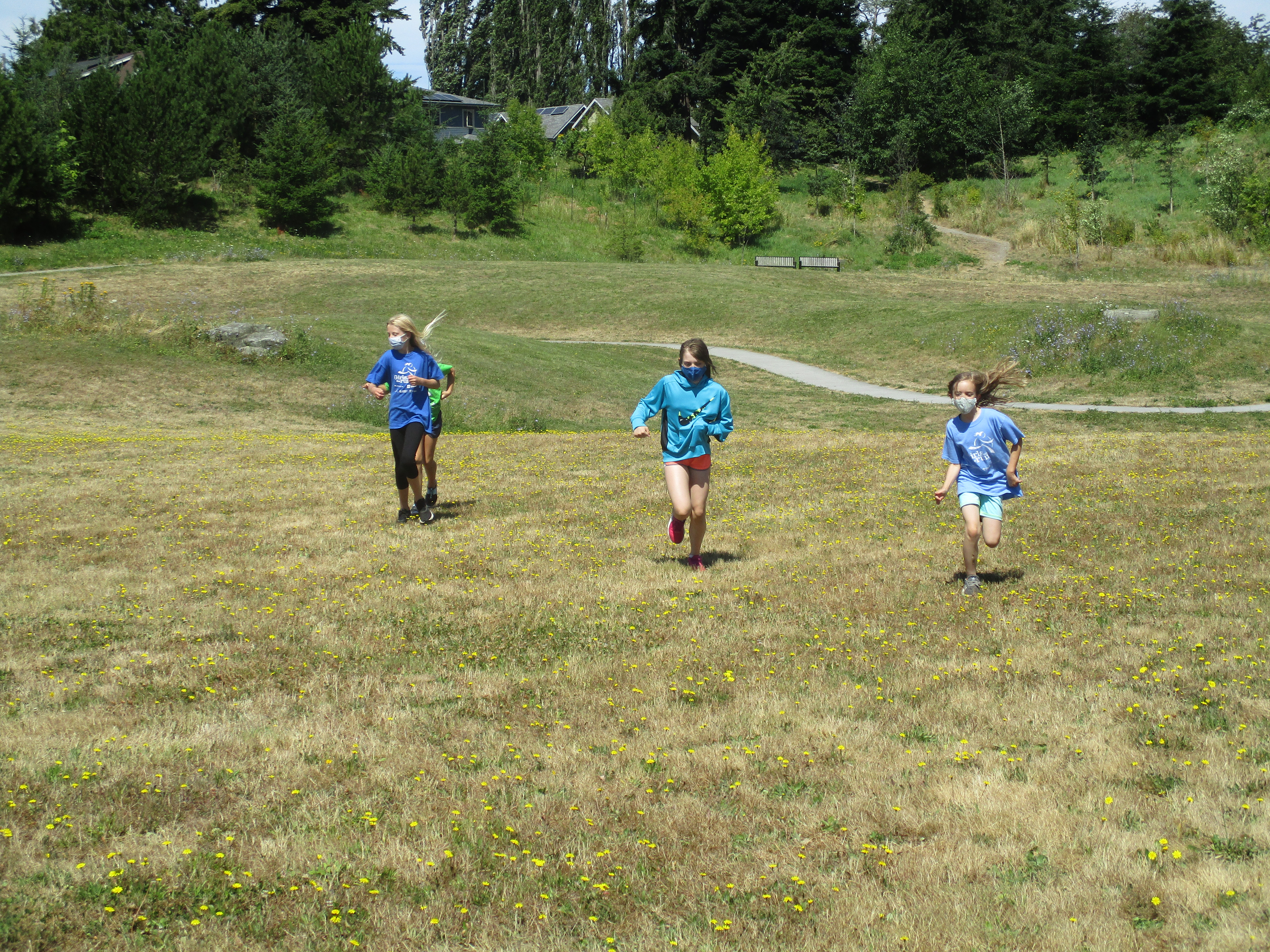 Girls running in field